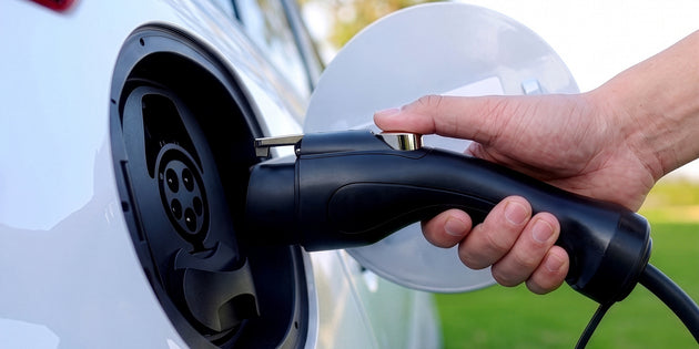 Type 1 connector of the Voldt® Portable Charger being plugged into a white electric car
